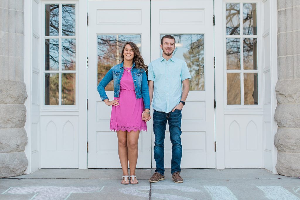 Woman and his boyfriend standing in front of white doors at Illinois State University 