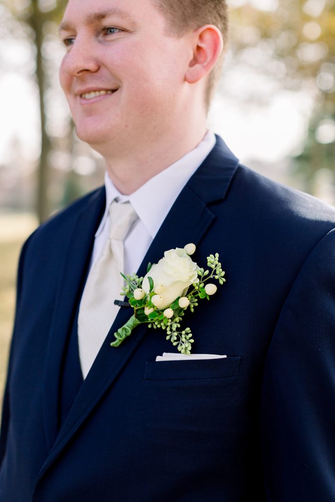 Close up photo of the flower on the grooms suit jacket on his wedding day. 