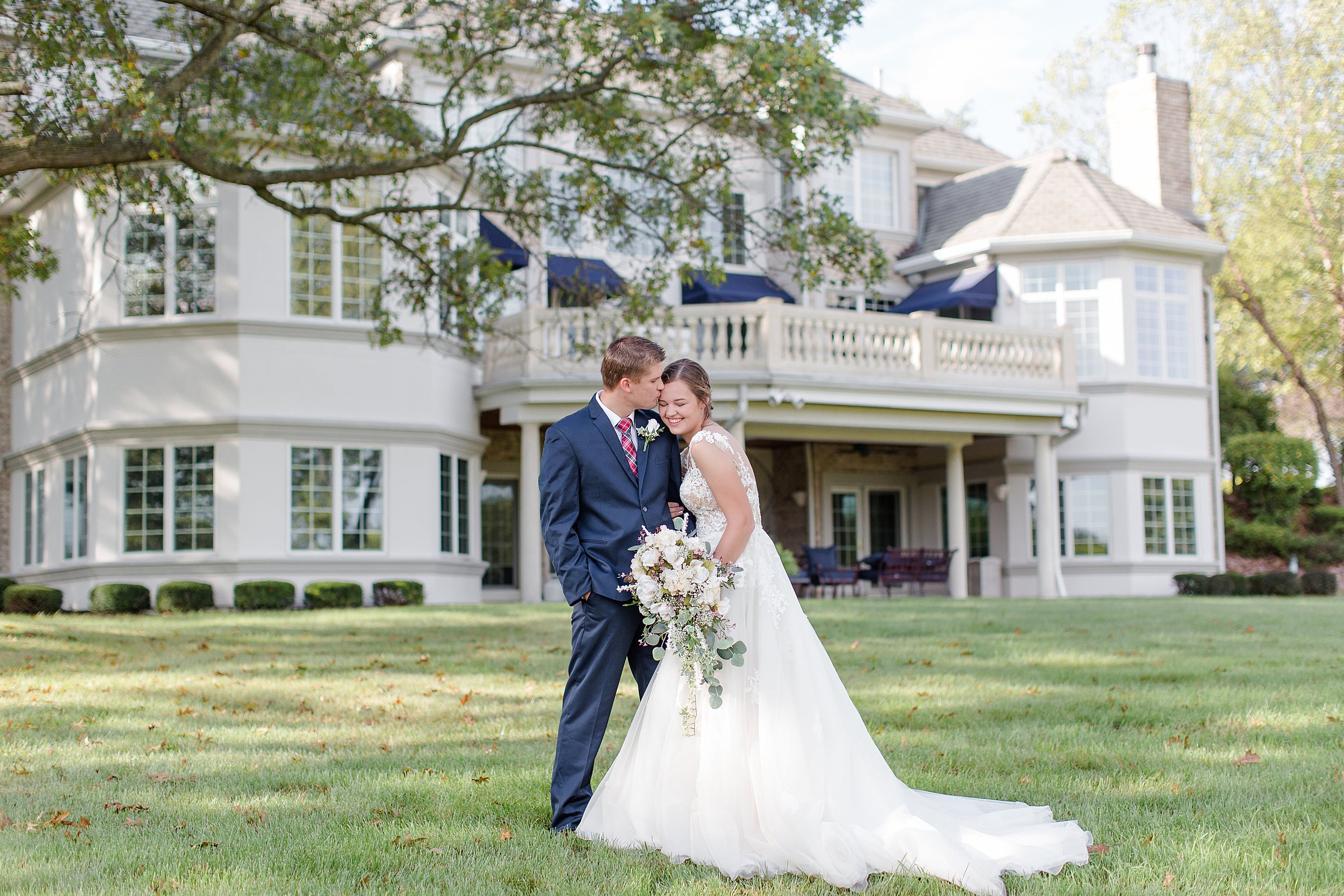 Indiana bride and groom posing in front of wedding venue