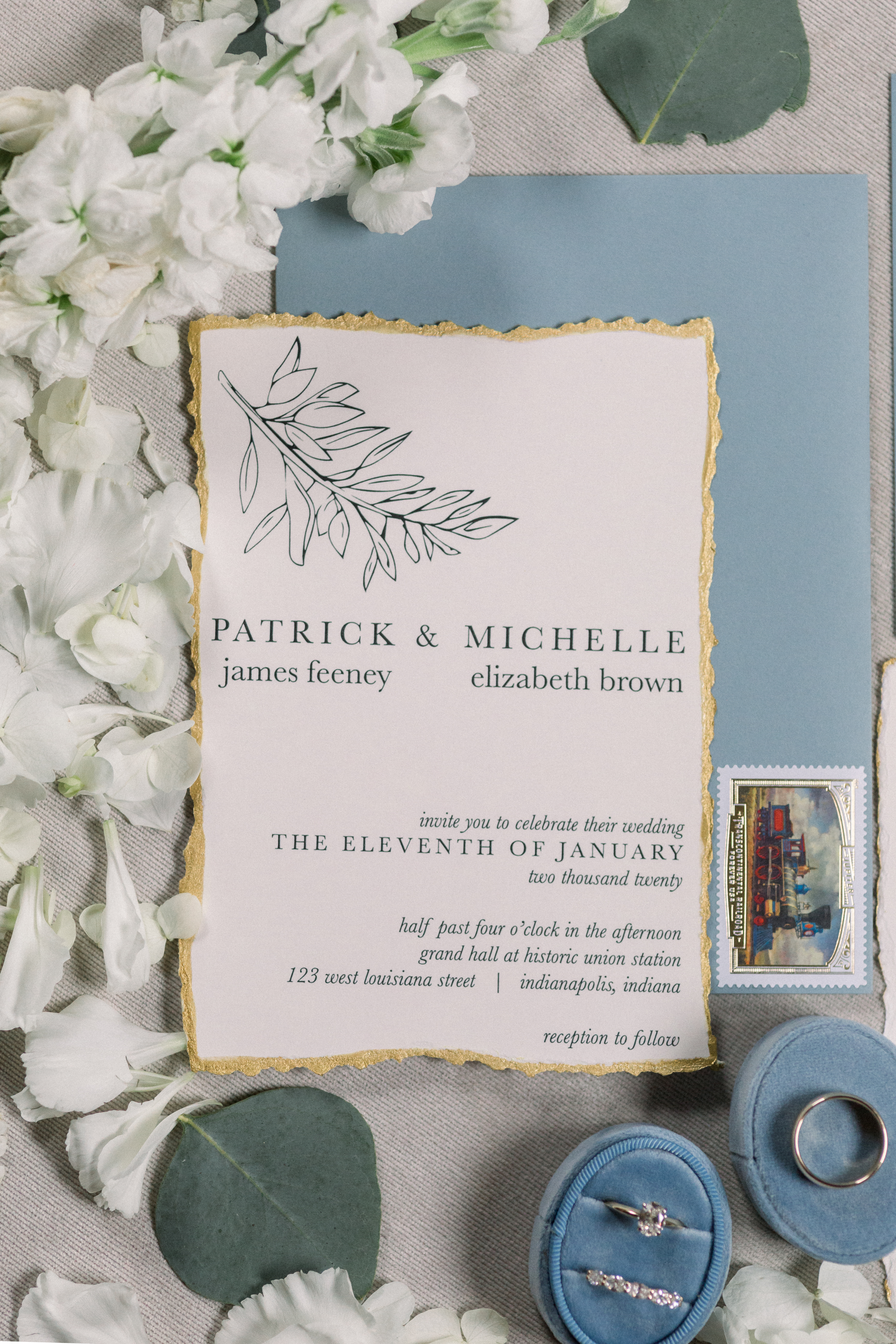 Wedding details including the invitations, rings and flowers